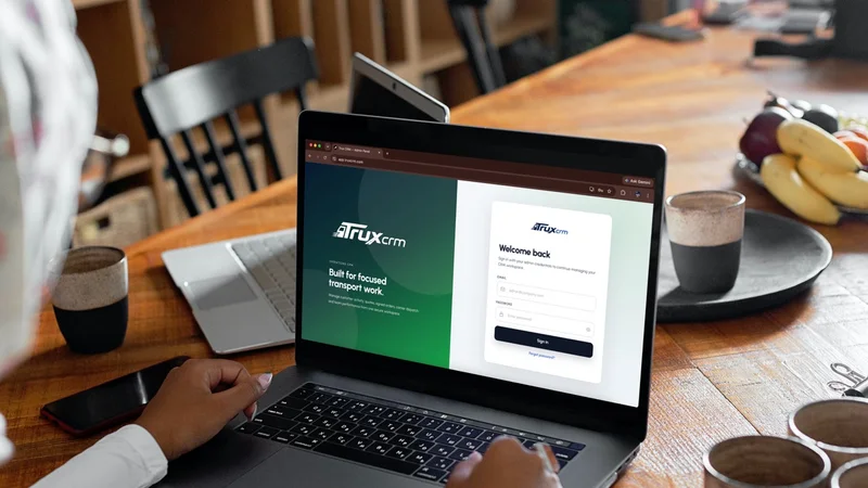 TruxCRM open on a laptop at a work table